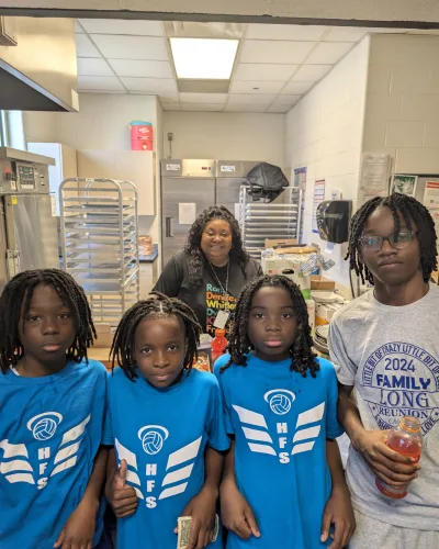 Group of Holy Family students in matching team shirts with their teacher